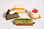 Assorted desserts including a green tea cake, a slice of chocolate cake, and a small white cake with strawberry on a white background.