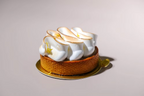 Small tart with meringue on a gray background