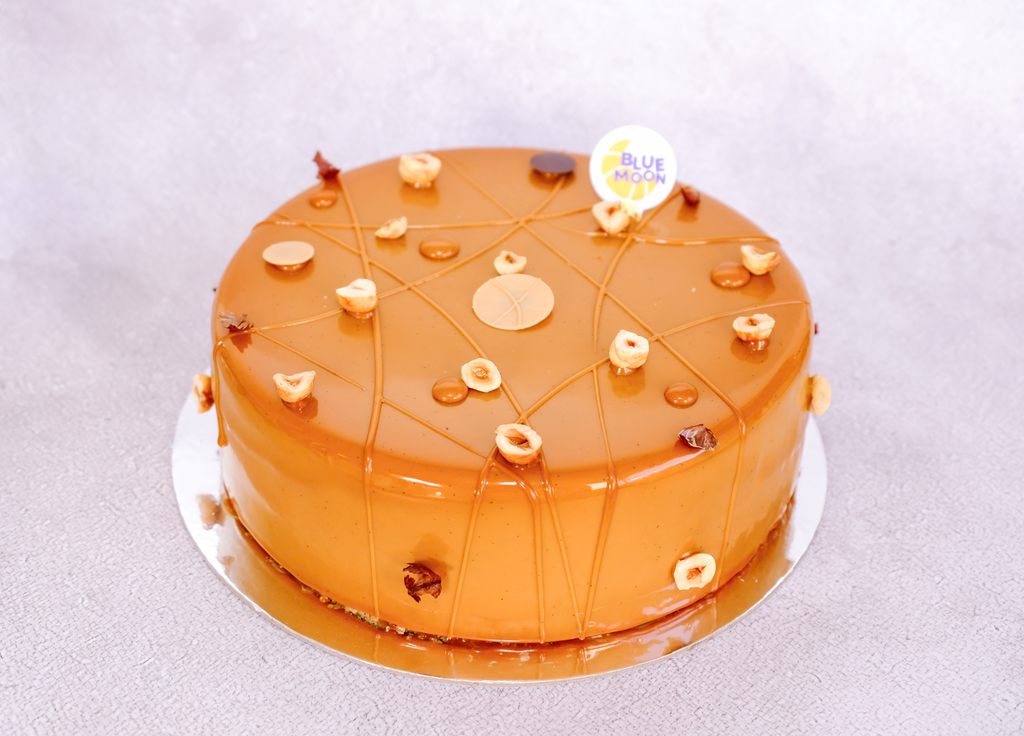 Four-layer hazelnut cake: milk choc mousse, hazelnut sponge, crispy praline & salted caramel glaze. 8" cake, 48hr pre-order. Christchurch.