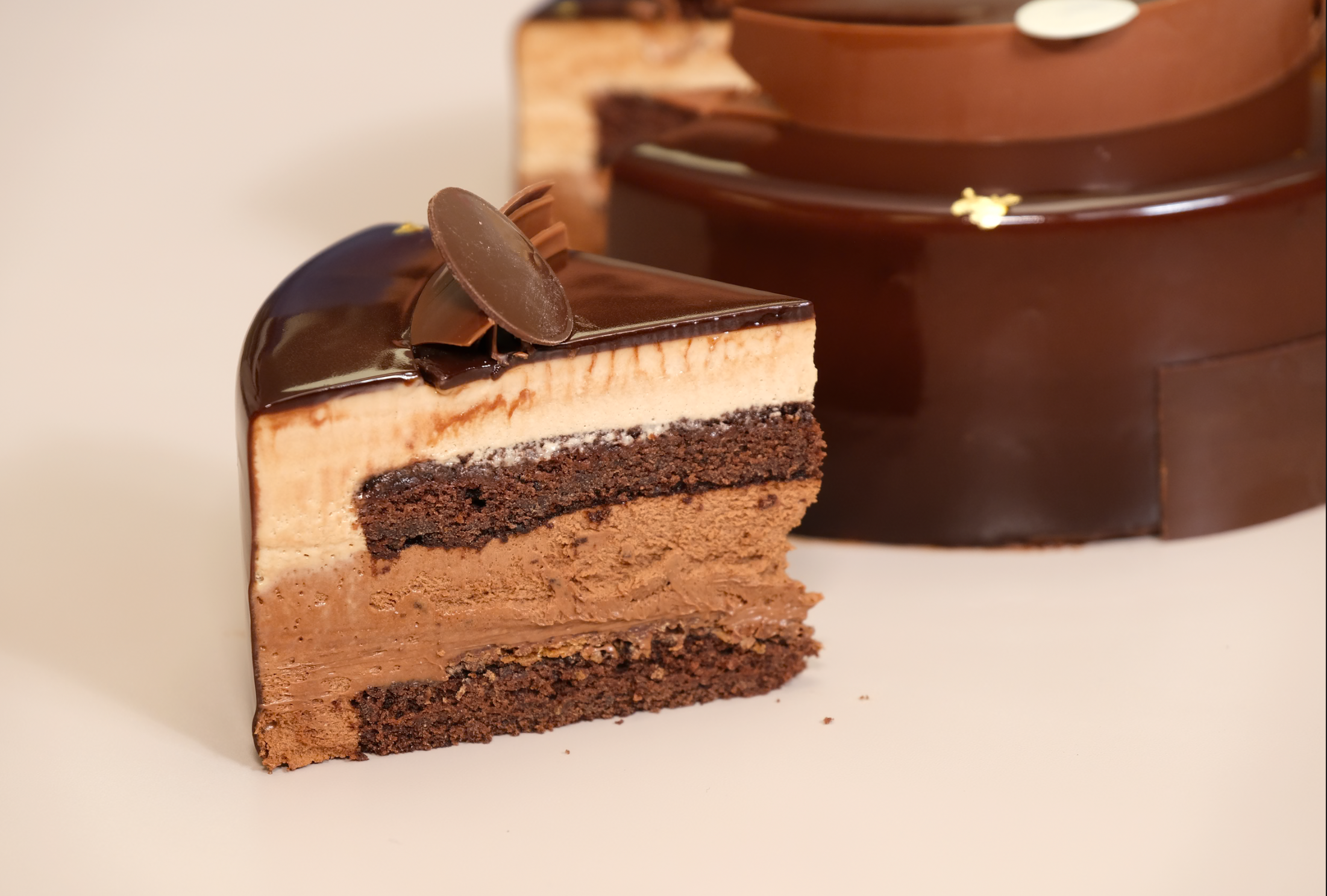 Three layers of chocolate mousse — dark, milk and white — in one decadent 8" cake. 48hr pre-order. Christchurch.